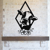 May include: Black metal silhouette of a cow's head with white markings, framed in a diamond shape with floral accents. The silhouette is mounted on a white brick wall.